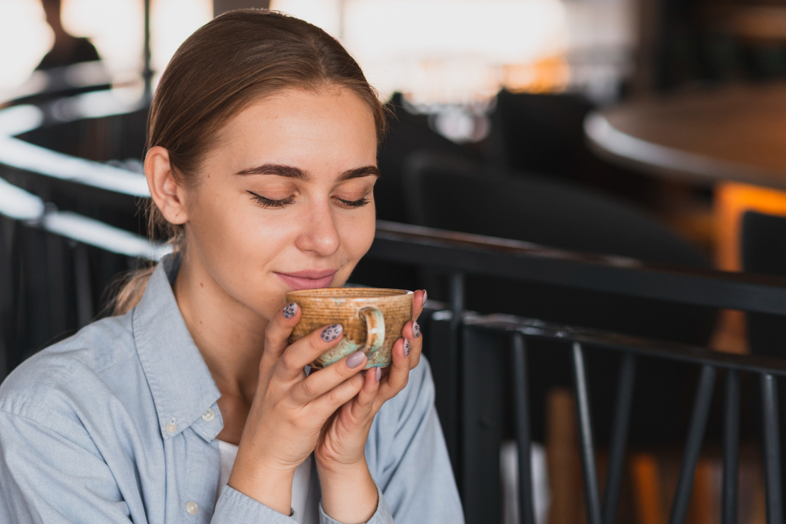 A serene image of a person's hands cradling a warm coffee mug, with soft, natural light and a calm, out-of-focus background, evoking a sense of peace and mindfulness.