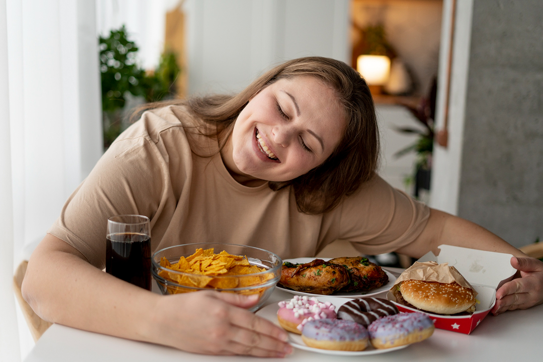 A woman finding comfort in food, illustrating emotional overeating.