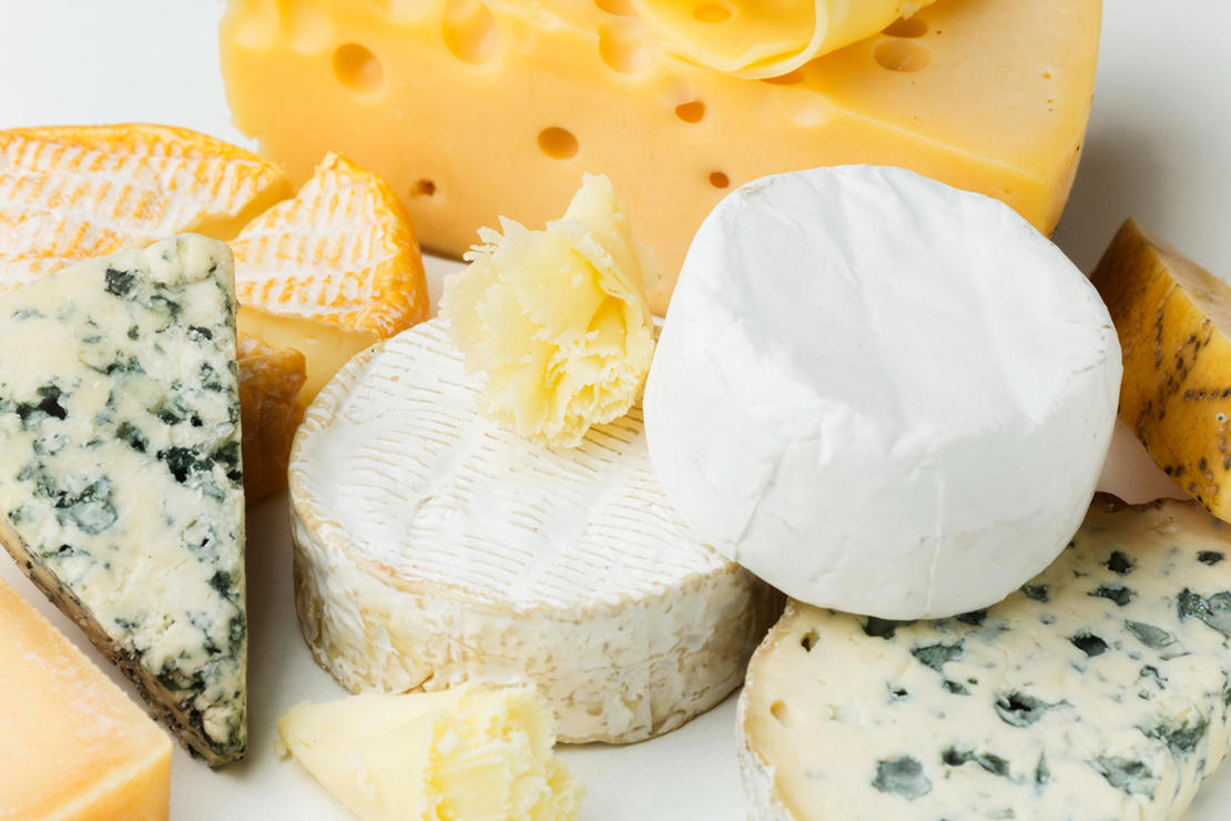 A vibrant display of cheddar, feta, and mozzarella cheeses, symbolizing diverse options for a calorie-conscious diet.