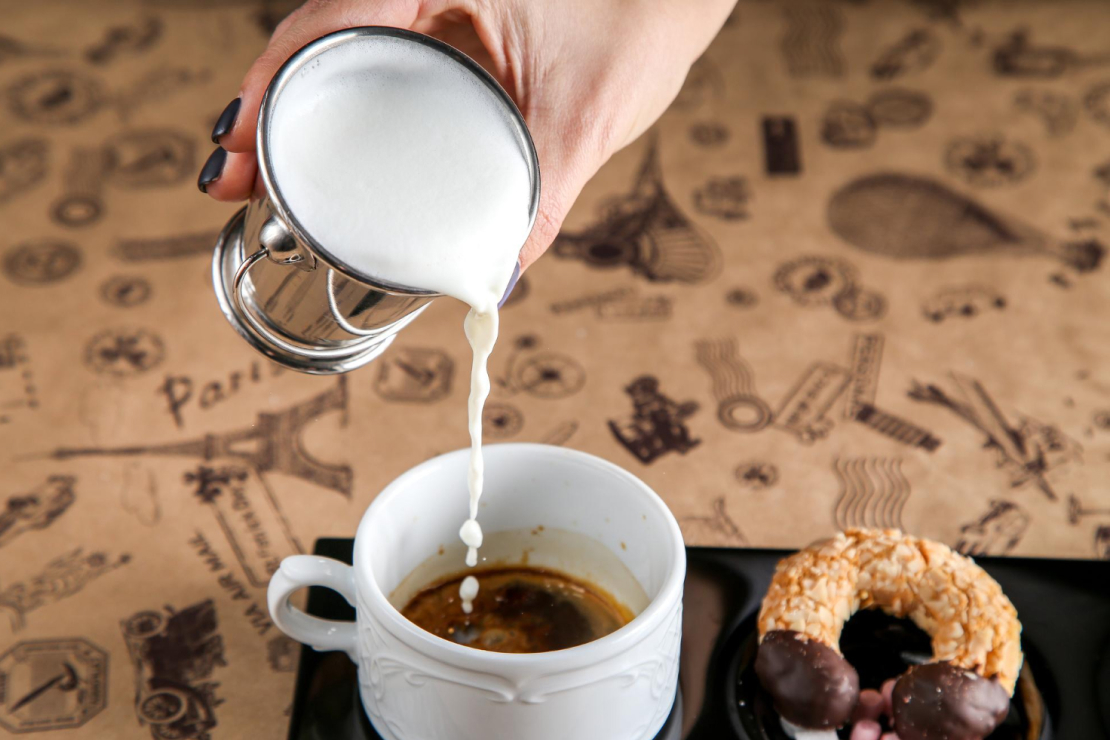 A comparison of cow's milk, almond milk, and oat milk in glasses, representing different dairy and plant-based milk options.